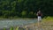 male traveller with disabilities is walking alone over mountain river shore