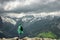 Male traveller on the top of mountain stormy landscape