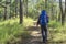 Male trekking backpacker in the pine forest