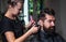 male trendy hairdo. perfect haircut with blade razor. barber master cut hair. mature hipster with beard at hairdresser