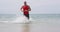 Male triathlete swimmer running out of ocean finishing swim - Triathlon swimming