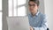 Male university student looking at laptop screen thoughtfully while doing homework. Closeup of concentrated boy trying