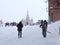 A male utility worker in Red Square shovels snow after a heavy snowfall