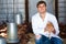 Male vet holding chicken in hen house