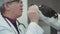 A male veterinarian gives dog treats during an inspection at the clinic