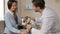 Male veterinarian queries woman about her pet