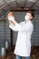 Male veterinarian in white coat holding brown chicken