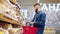 male visitor is buying bread in bakery in supermarket