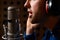 Male Vocalist Singing Into Microphone In Recording Studio