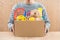 Male volunteer holding donation box with old toys.