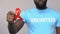 Male volunteer holding red ribbon, solidarity of people living with HIV and AIDS