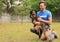 Male volunteer with homeless dog at animal shelter