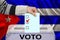 Male voter drops a ballot in a transparent ballot box against the background of the Cuba national flag, vote in spanish, concept