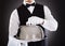 Male waiter holding tray and lid