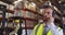 Male warehouse manager talking with headset in loading bay 4k