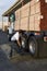 Male Warehouse Worker Tightening Belt Of A Trailer