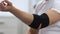 Male wearing elbow padded orthosis, comfortable orthopedic support, trauma