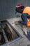 Male welder is welding new steel grate, arc welding process with sparks. Industrial worker concept. Long exposure