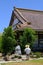 Male in a white shirt gazing upon a statue in front of the San Jose Buddhist Church Betsuin