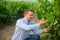 Male winemaker working with grapes in vineyard at fields