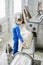 Male worker cleaning get carpet from an automatic washing machine and carry it in the clothes dryer