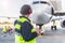 Male worker controlling aircraft and writing information