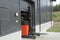 Male worker driving out of a warehouse on the fork-lift-truck