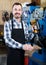 male worker fixing failed shoes in shoe repair workshop