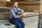 Male Worker folds boards. Sawmill. Wood harvesting process