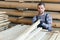 Male Worker folds boards. Sawmill. Wood harvesting process