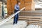 Male Worker folds boards. Sawmill. Wood harvesting process