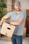 male worker holding cardboard box