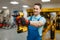 Male worker holds battery screwdriver, tool store