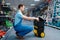 Male worker holds toolbox on wheels in tool store