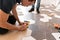 Male worker installing new wooden laminate flooring. The combination of wood panels of laminate and ceramic tiles in the