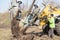 Male worker operates tree transplanter heavy machine. Landscaping, seasonal agricultural engineering, large trees landing machines