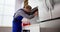 Male Worker In Overall Testing Kitchen Hood With Multimeter