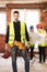 Male worker on a residential construction site with his team of engineers working in the background