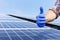 Male worker showing thumbs up, positive gesture against solar panel, solar station. Like to alternative energy sun energy power.