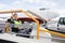 Male Worker Sitting On Luggage Conveyor Truck