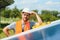 Male worker with solar batteries. Man in a protective helmet. Installing stand-alone solar panel system