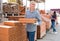 Male worker stacks thermal insulation panels at warehouse