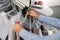 Male worker taking clothes from garment conveyor at dry-cleaner`s, closeup