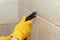 Male worker tiling a wall.