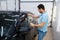 Male worker tries on wetted car tinting, tuning