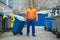 Male Worker Walking With Dustbin On Street