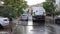 Male worker washing and disinfecting a street