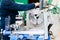 A male worker works on a larger metal iron locksmith lathe, equipment for repairs, metal work in a workshop at a metallurgical