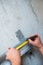 Male worker works with profile for drywall, marker marks for cutting. Construction work, repair.