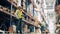 Male workers are inspecting and unloading items in the warehouse